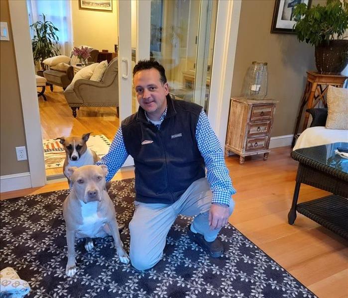Construction manager Nelson Valada poses with his two dogs