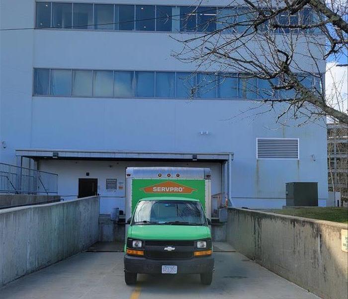 SERVPRO box truck parked at loading bay of large building