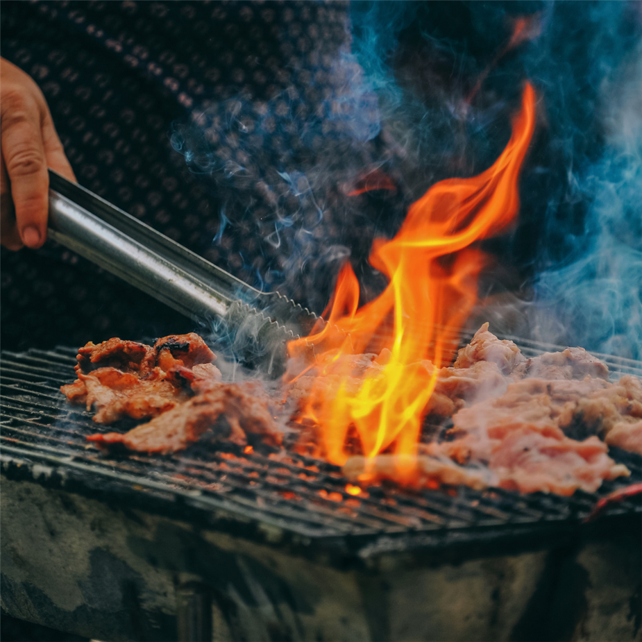 flames flaring above grate while cooking meats