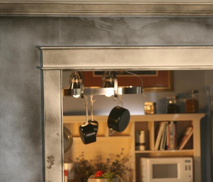 Smoke damaged doorway looking into a kitchen